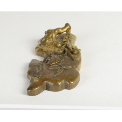 9026 - A Chinese bronze scroll weight in the form of blossoming branches and bamboo, Qianlong four characte... 