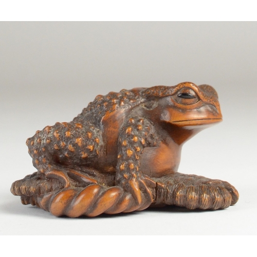 9061 - MASANAO: a wooden netsuke in the form of a toad on a broken waraji (sandal), signed to base
2.5cm hi... 