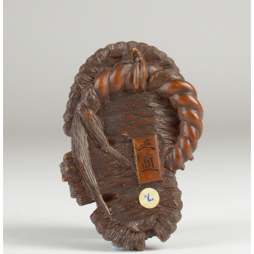 9061 - MASANAO: a wooden netsuke in the form of a toad on a broken waraji (sandal), signed to base
2.5cm hi... 