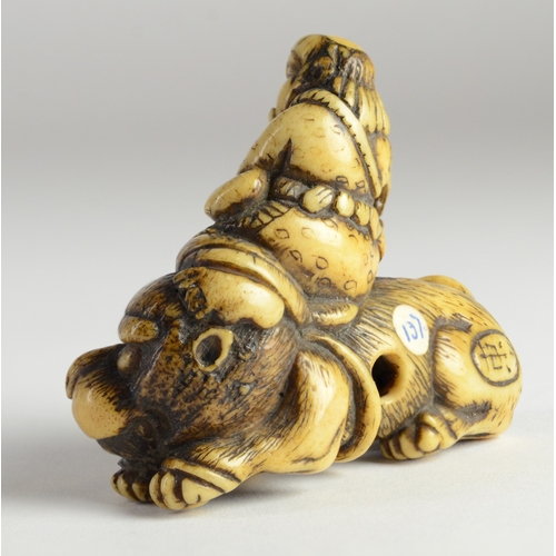 9036 - TOZAN-A stag's horn netsuke of Monju Bosatsu on a lion's back, playing the flute- signed Tozan in ov... 