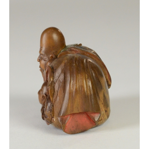 9051 - SHUZAN a wooden and partially lacquered netsuke depicting Fukurokuju with Hotei in his bag, signed t... 