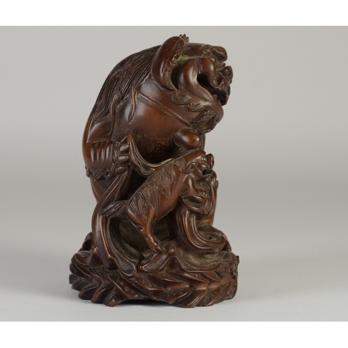 9002 - A carved wooden figure of a shishi and pup, unsigned

10cm high

Provenance
Henry Potter & Dorothy A... 