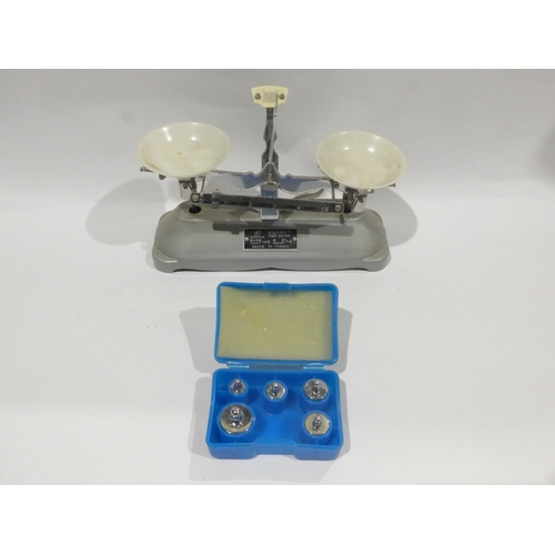 A miniature table balance scales and weights