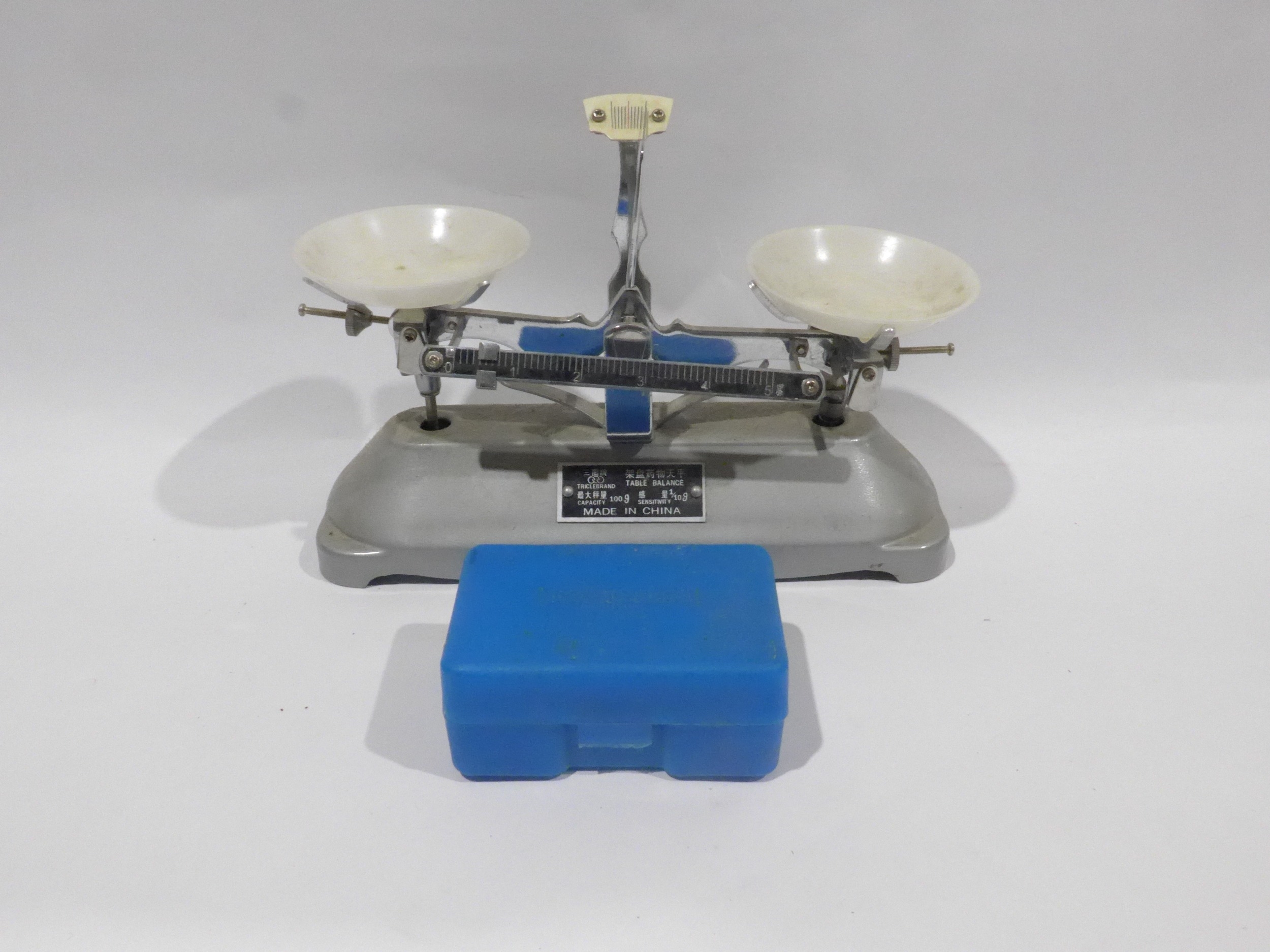 A miniature table balance scales and weights