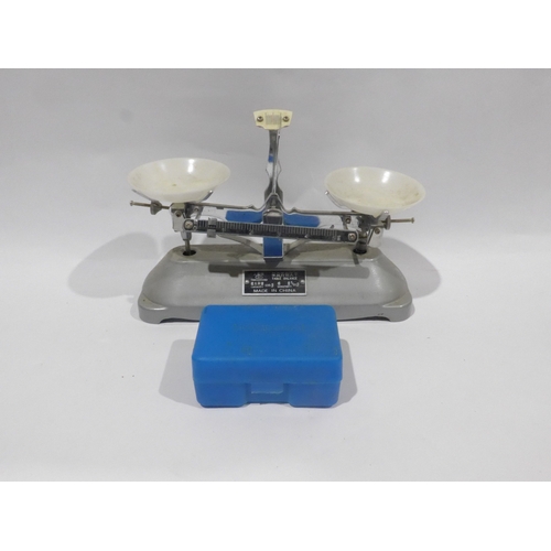 A miniature table balance scales and weights