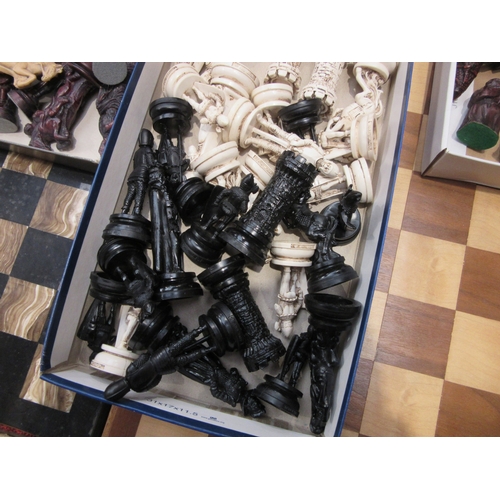 8023 - A collection of chess sets with wooden and onyx boards