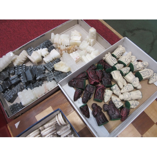 8023 - A collection of chess sets with wooden and onyx boards