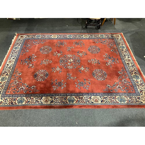 1469 - A Chinese red ground carpet, foliate patterns and border, approximately 365cm x 275cm