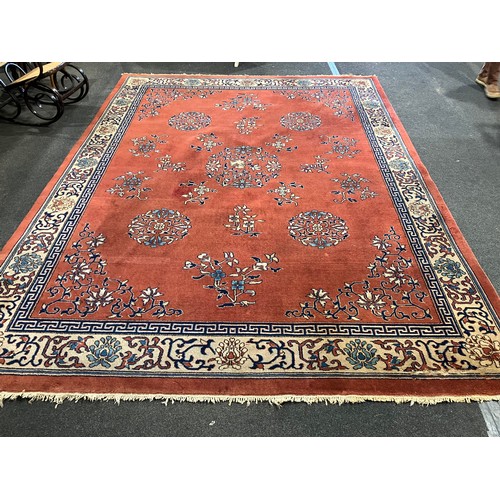 1469 - A Chinese red ground carpet, foliate patterns and border, approximately 365cm x 275cm
