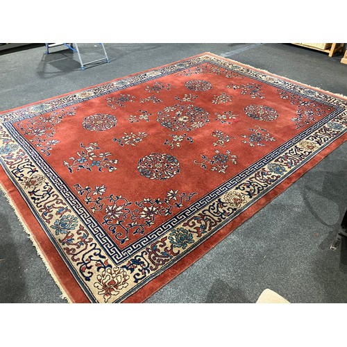 1469 - A Chinese red ground carpet, foliate patterns and border, approximately 365cm x 275cm