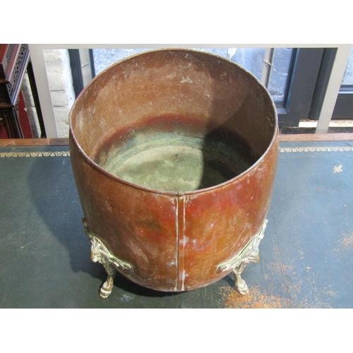 1002 - An oval-form copper jardinière, with four brass feet with rams-heads and cloven hoof terminals, 27.5... 