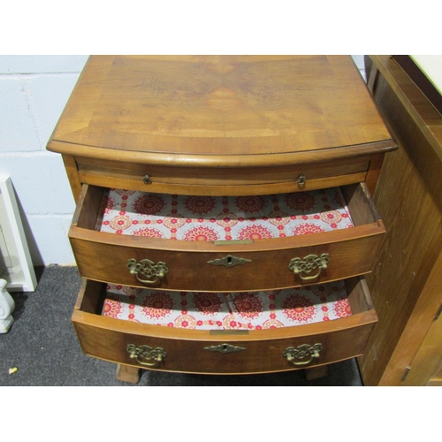 1028 - A walnut bow fronted bachelor's chest of four drawers with brushing slide, brass fittings, 77cm tall... 