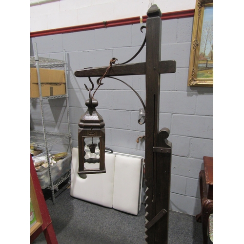 1037 - A lantern form height adjustable oak standard lamp