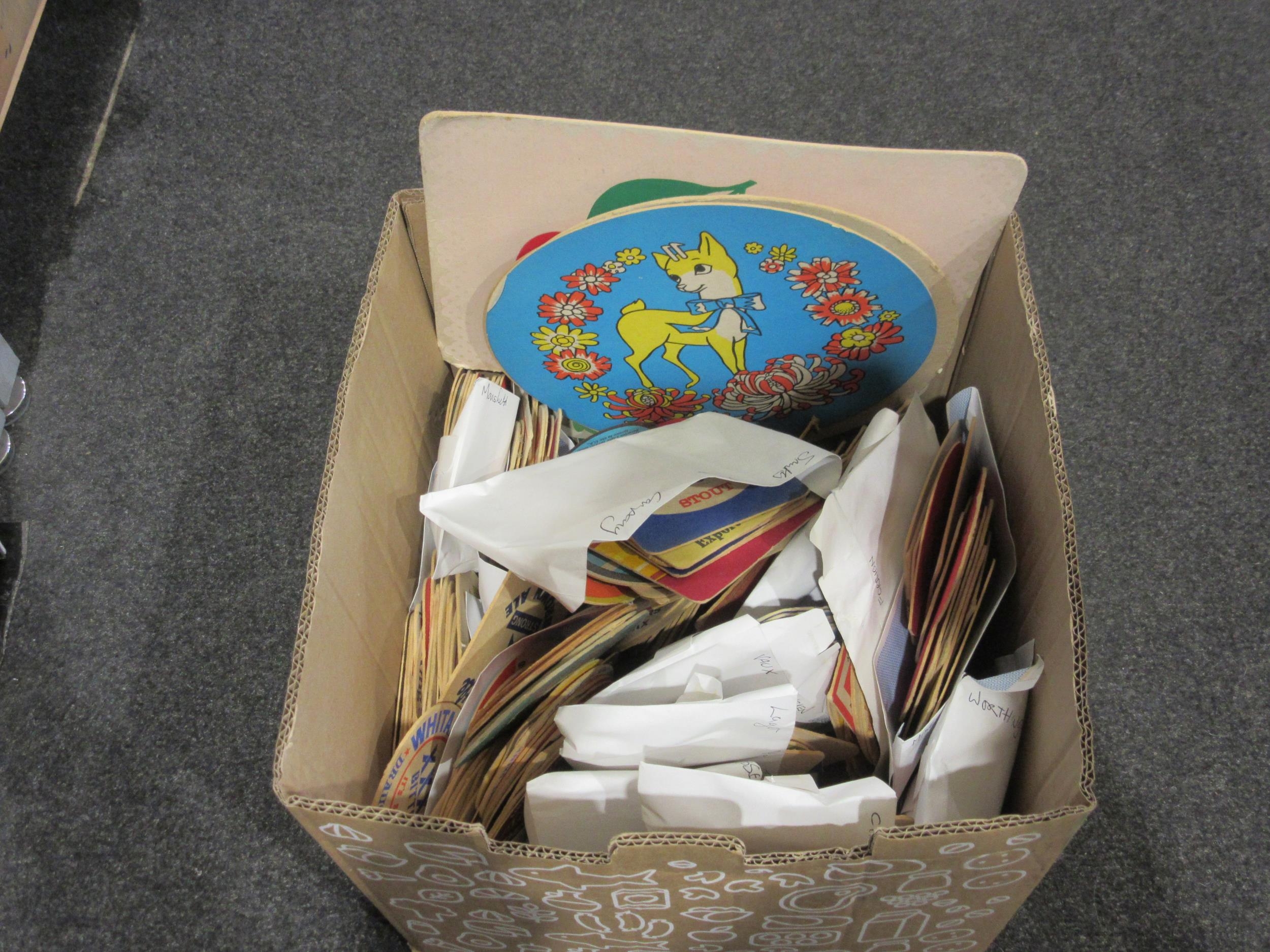 A box containing a quantity of vintage beer mats to include 70's ...