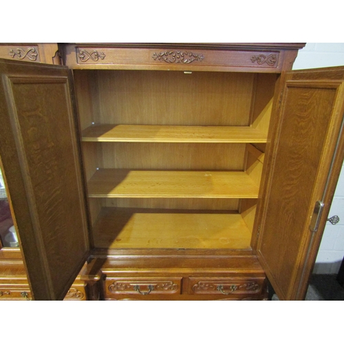 1013 - A large medium oak breakfront five door bookcase/cabinet with keys over a five drawer base on French... 
