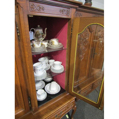 1013 - A large medium oak breakfront five door bookcase/cabinet with keys over a five drawer base on French... 