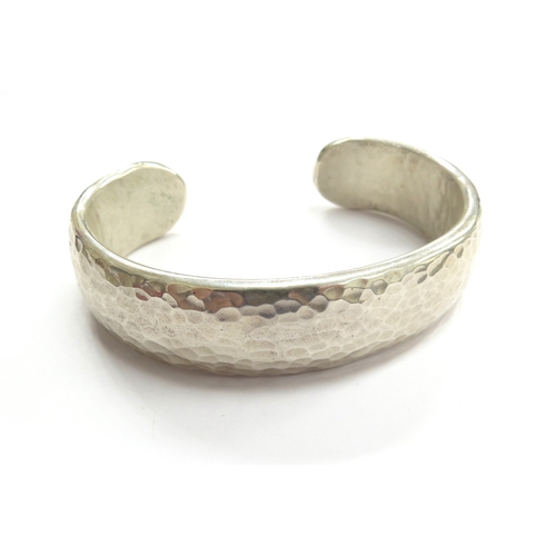6561 - A heavy planished silver cuff bangle, 154.7g