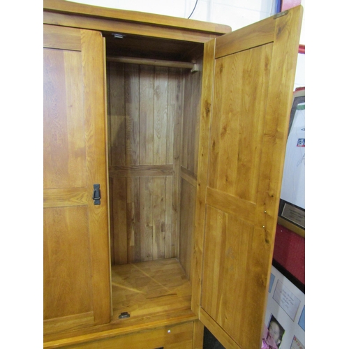 1050 - A modern oak wardrobe, two doors over single drawer base, 193cm x 110cm wide x 58cm deep