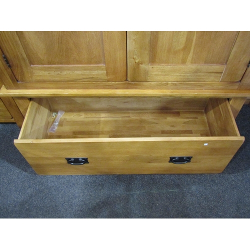 1050 - A modern oak wardrobe, two doors over single drawer base, 193cm x 110cm wide x 58cm deep