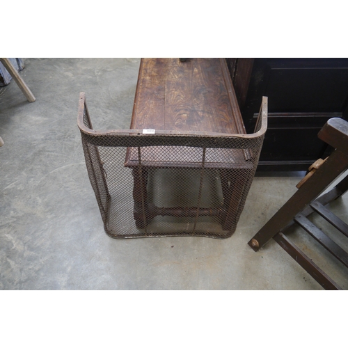 2006 - A wrought iron and wire fire screen