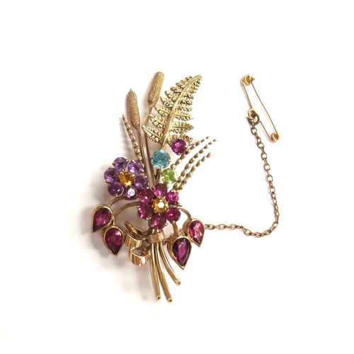 6054 - A 9ct gold brooch as a posy of semi-precious stone set flowers, fern frond and bullrushes, maker's m... 