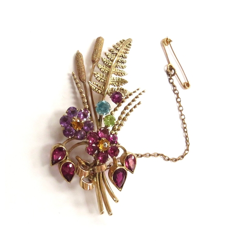 6054 - A 9ct gold brooch as a posy of semi-precious stone set flowers, fern frond and bullrushes, maker's m... 