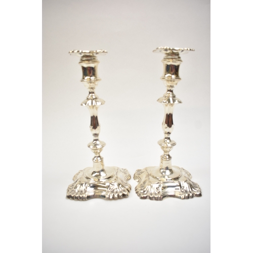 8032 - A pair of William Hutton & Sons Ltd silver candlesticks with weighted bases. Both bases are engraved... 