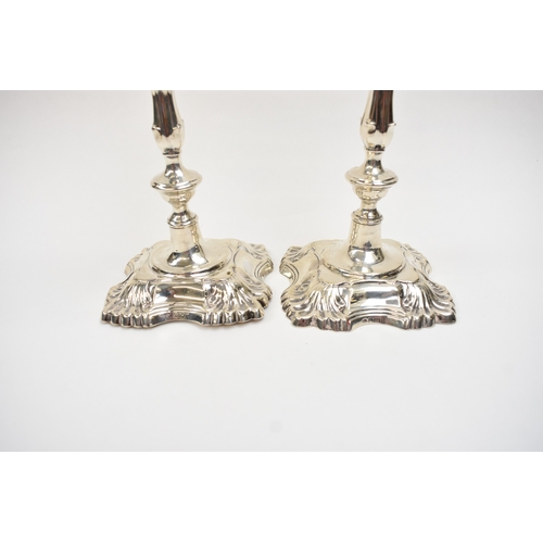 8032 - A pair of William Hutton & Sons Ltd silver candlesticks with weighted bases. Both bases are engraved... 