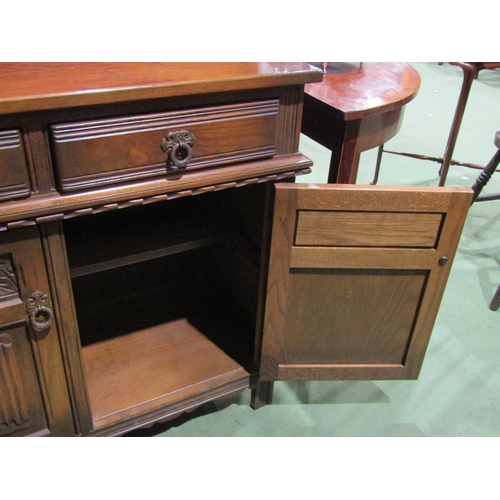 4052 - An oak Old Charm style cupboard, two drawers over two doors, with linen fold detail, 81cm tall x 93c... 