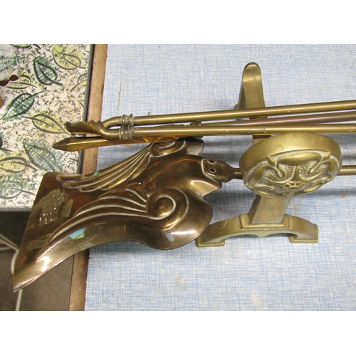 2058 - A brass fire companion set with fire dogs