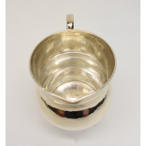 8046 - A Theodore Rossi silver cream jug with banded neck, London 1918, base marked Rossi Norwich.  186g