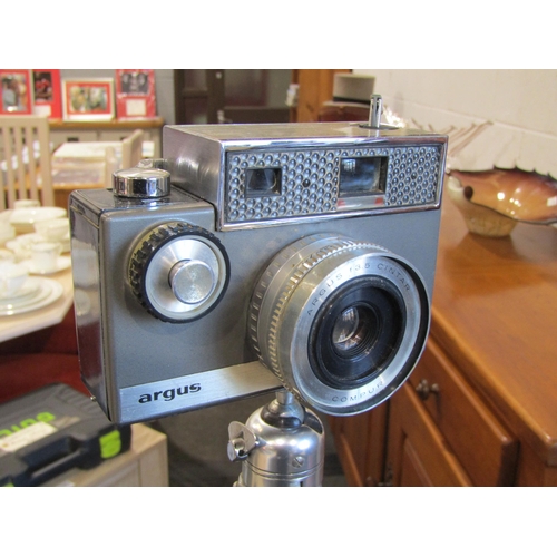 1025 - A vintage Argus camera on an extending tripod