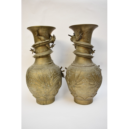 1044 - WITHDRAWN - Circa 1900 a pair of Chinese brass urns with high relief Dragons chasing the flaming pea... 