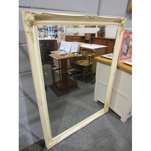 1052 - A large bevel edged mirror in the shabby chic style, 137cm x 106cm