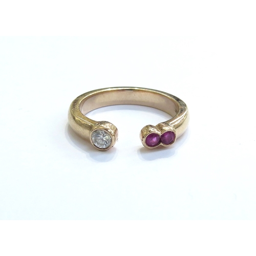 6050 - A 9ct gold open front ring the ends terminating in two rubies and single diamond. Size N, 4.1g