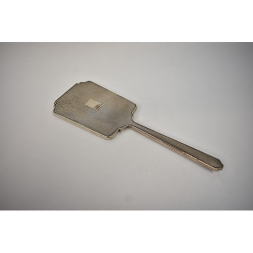 8049 - A silver hand mirror of Deco form
