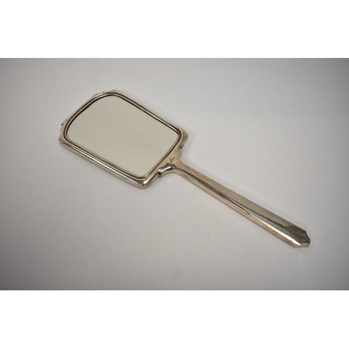 8049 - A silver hand mirror of Deco form