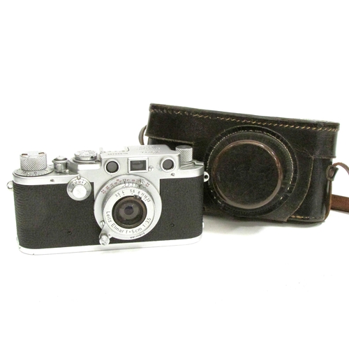 7015 - A 1950s Leica DRP Ernst Leitz Wetzlar IIIf 35mm film Rangefinder camera, serial 599495, with attache... 