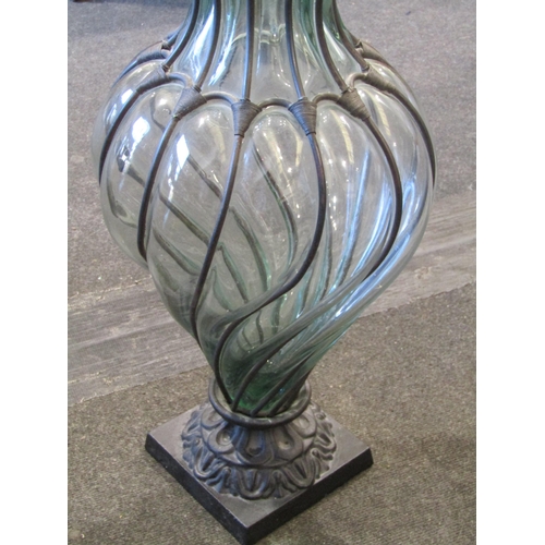 1026 - A cast and wrought iron with blown glass vase, 69cm high