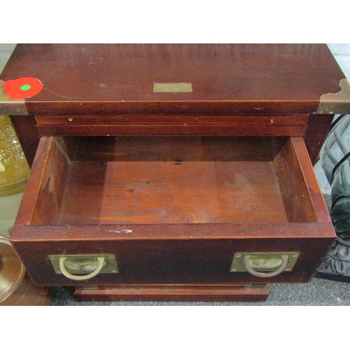 1029 - A campaign style mahogany chest of three drawers, flush brass handles and straps, 60cm tall x 47cm w... 