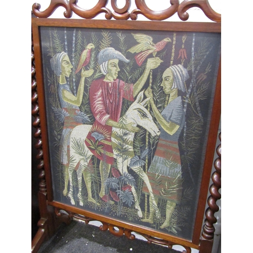1036 - A large woven panel fire screen, framed in mahogany with barley-twist supports over scrolling feet, ... 