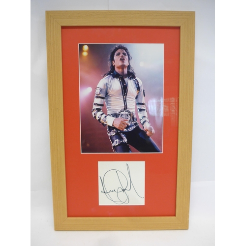 8298 - Michael Jackson autograph - A white card signed in black marker pen by Michael Jackson, mounted with... 