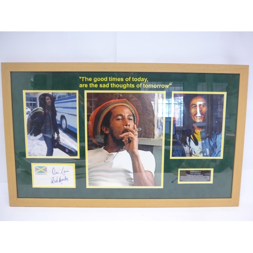 8287 - Bob Marley autograph - A white card with the Jamaican flag to corner signed in blue marker pen 