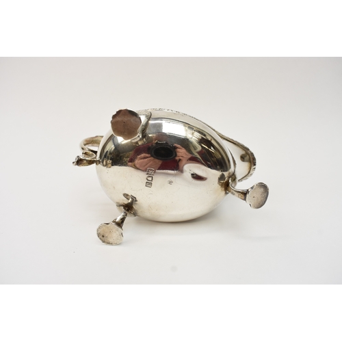 8052A - A silver sauce boat, gadrooned edge, shell relief feet, Longfield crest, scroll handle, with dents t... 