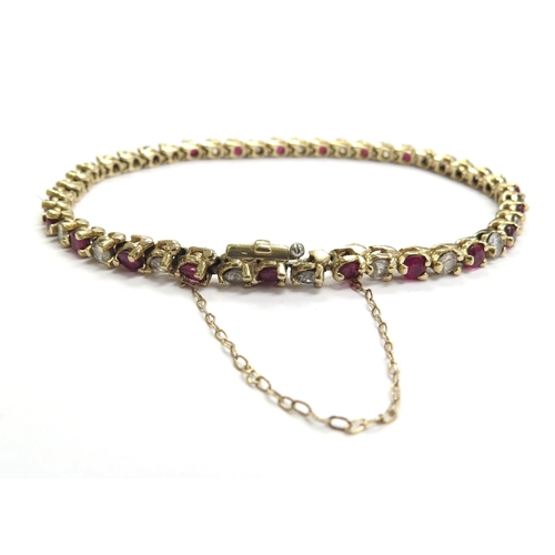 6016 - A yellow gold ruby and diamond line bracelet total ruby weight 3.22ct, diamond weight 1.84ct, 14ct, ... 
