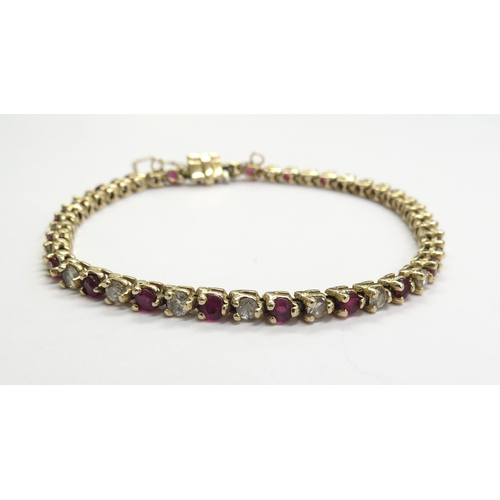 6016 - A yellow gold ruby and diamond line bracelet total ruby weight 3.22ct, diamond weight 1.84ct, 14ct, ... 