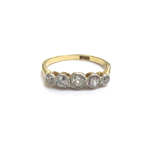 6336 - An 18ct gold five stone graduated collet set diamond ring. Size M/N, 2.1g