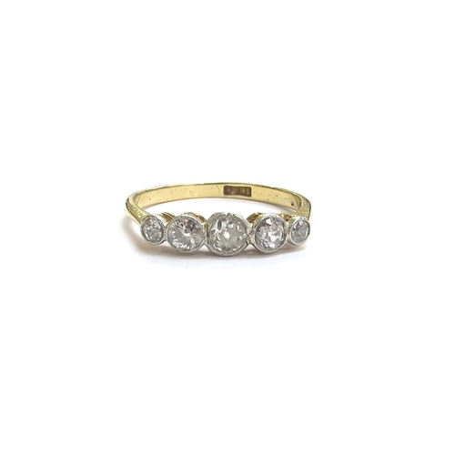 6336 - An 18ct gold five stone graduated collet set diamond ring. Size M/N, 2.1g