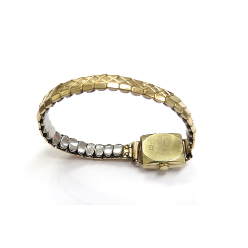 6131 - A gold cased wristwatch stamped 585 with metal strap, 14.7g total