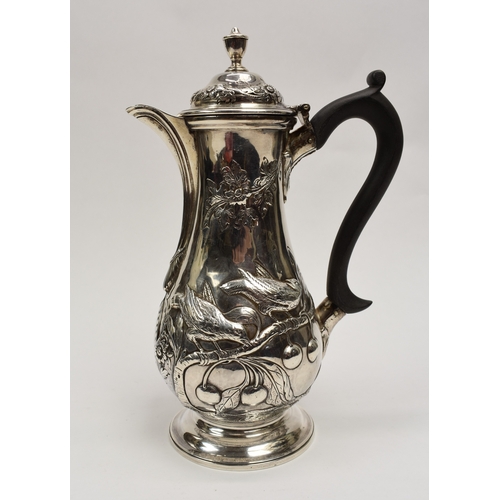 8012 - A George III silver hot water jug/coffee pot.  The body decorated in high relief with birds, flowers... 